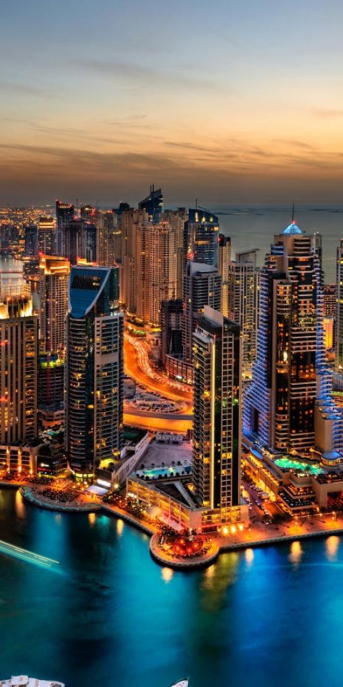Tram gliding along Dubai Marina in daylight