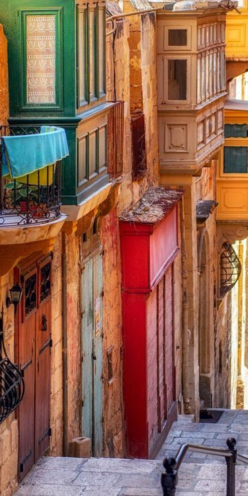 Valletta tram passing historic buildings