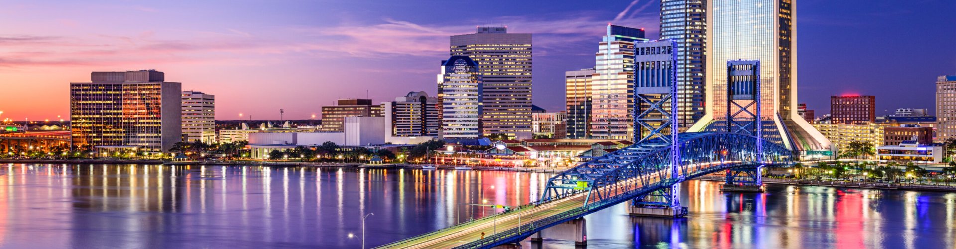 Night tram gliding across cobblestone street in Jacksonville