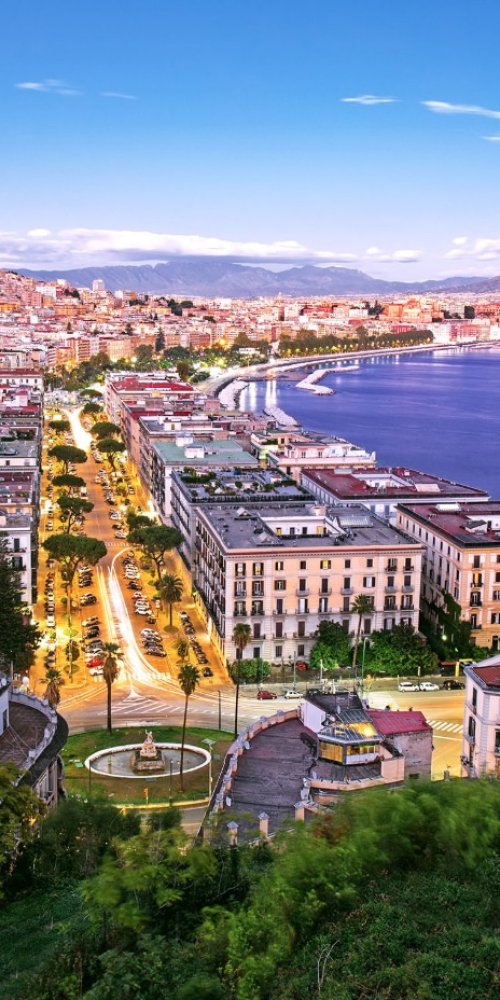 Naples tram along narrow street in soft afternoon light