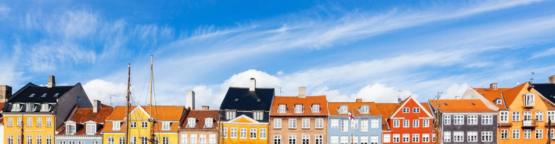 Night tram crossing cobblestone street in Copenhagen