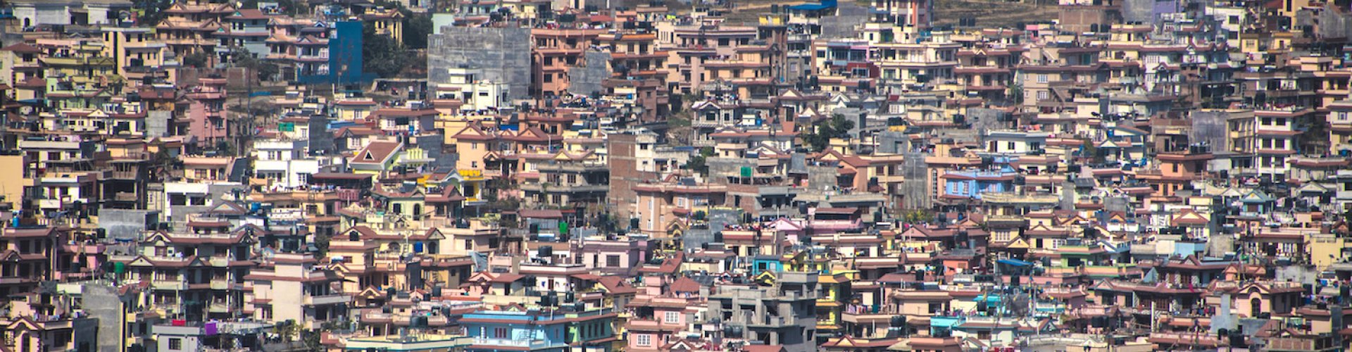 Night tram gliding over cobblestone street lit by lampposts