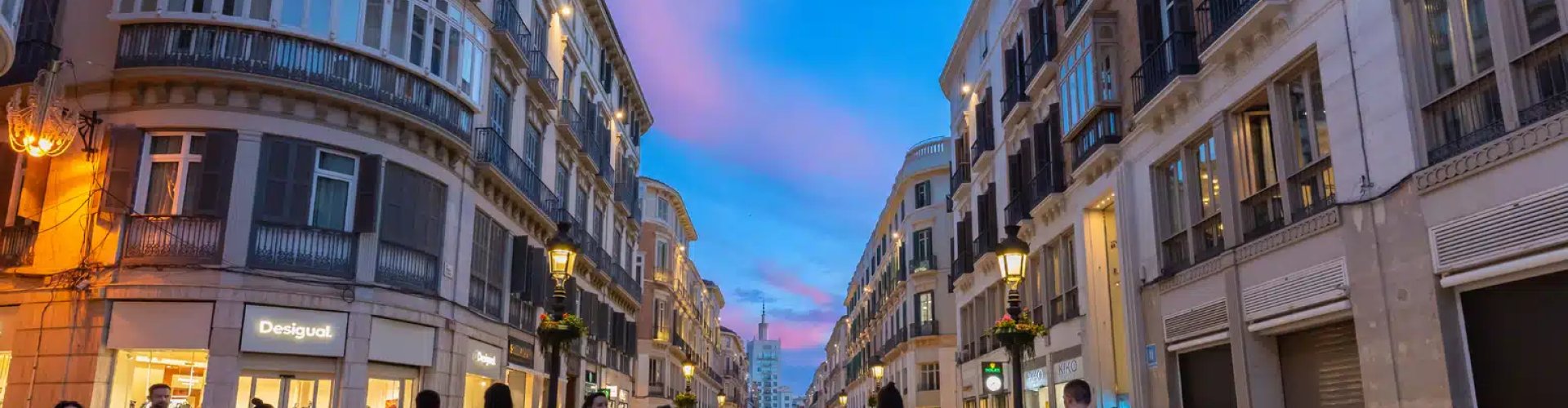 Night tram in Málaga on cobblestone street