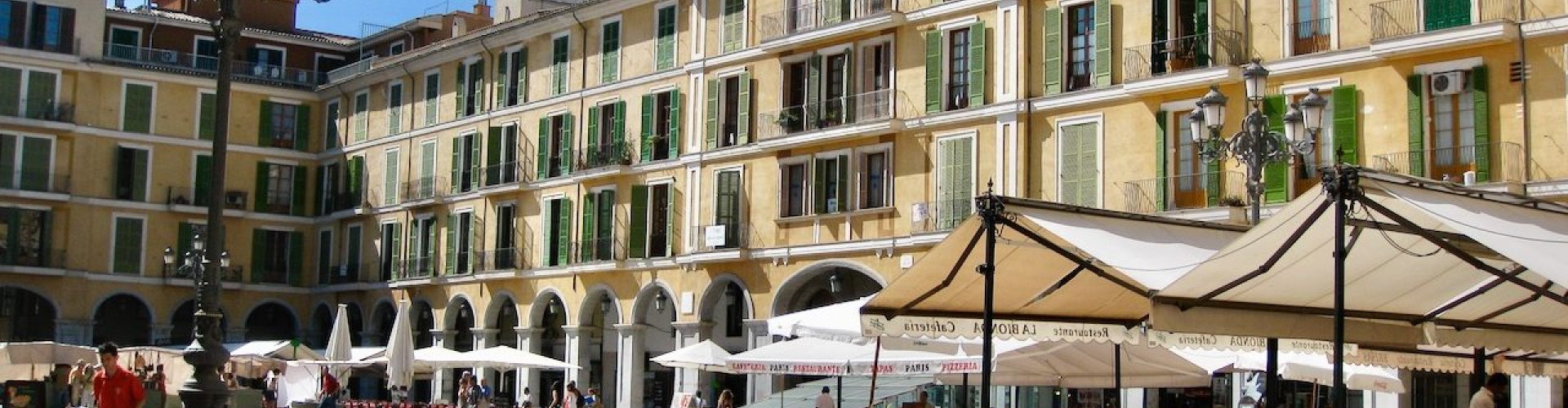 Night tram running on Palma de Mallorca's cobblestone street