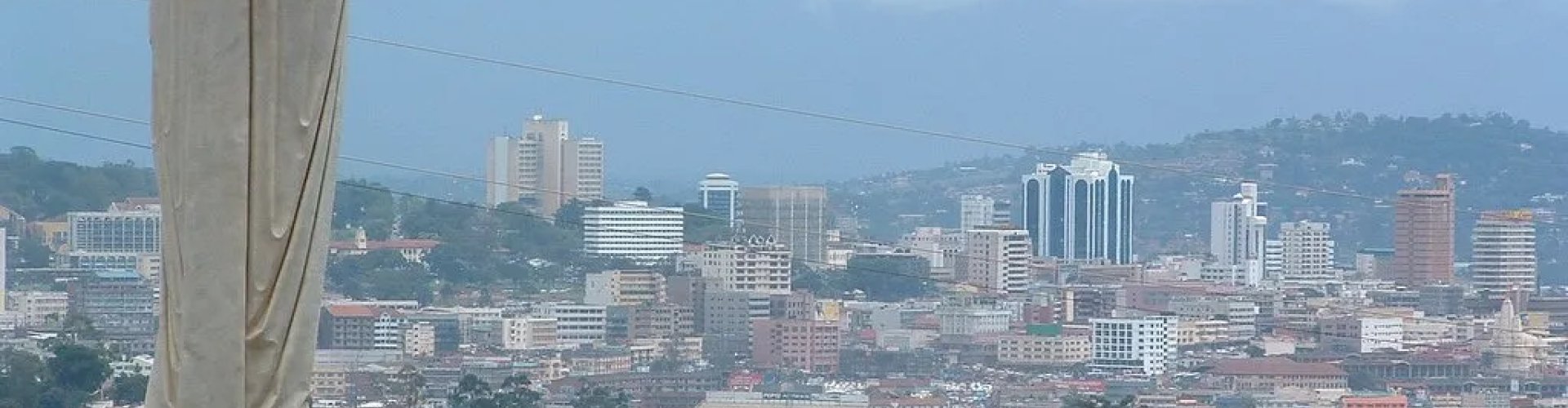Busy Kampala Metro entrance with commuters