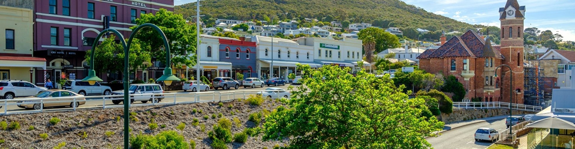 Night-time tram gliding past cobblestone street in Albany