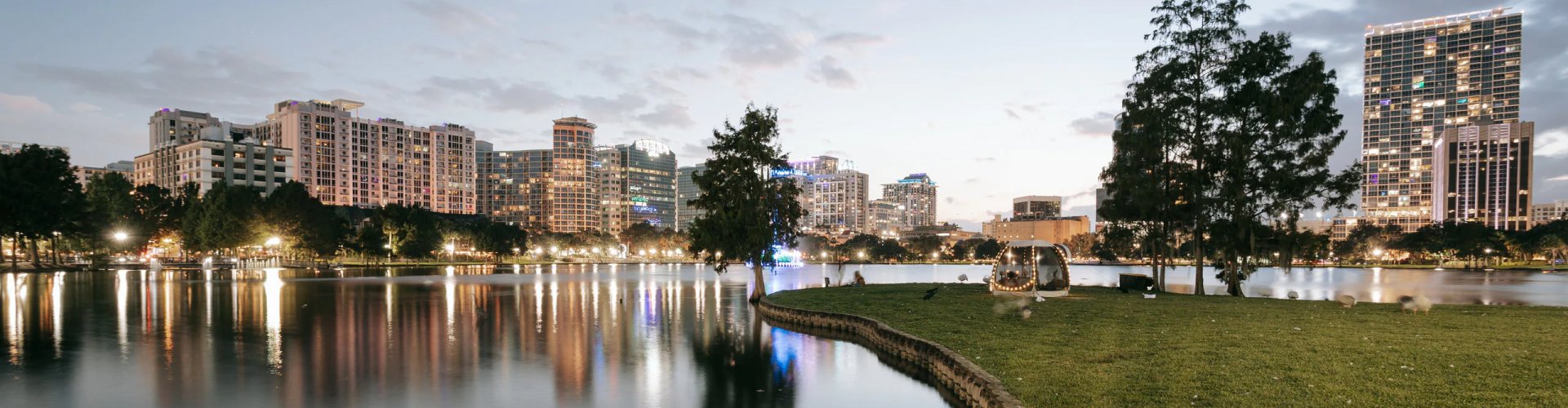 Night tram gliding over cobblestone street in Orlando