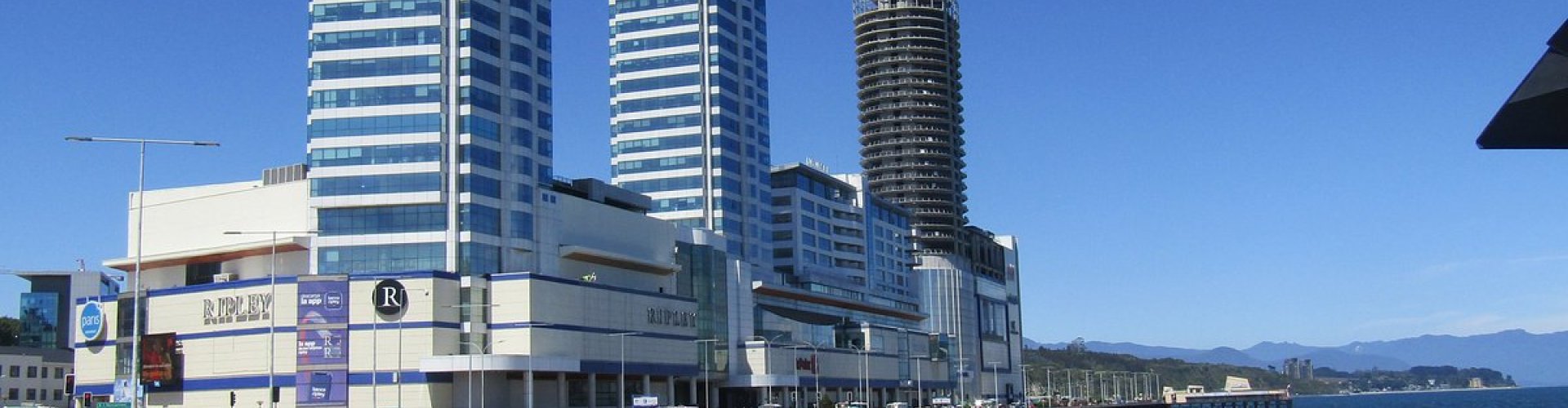 Night tram gliding over cobblestones in Puerto Montt