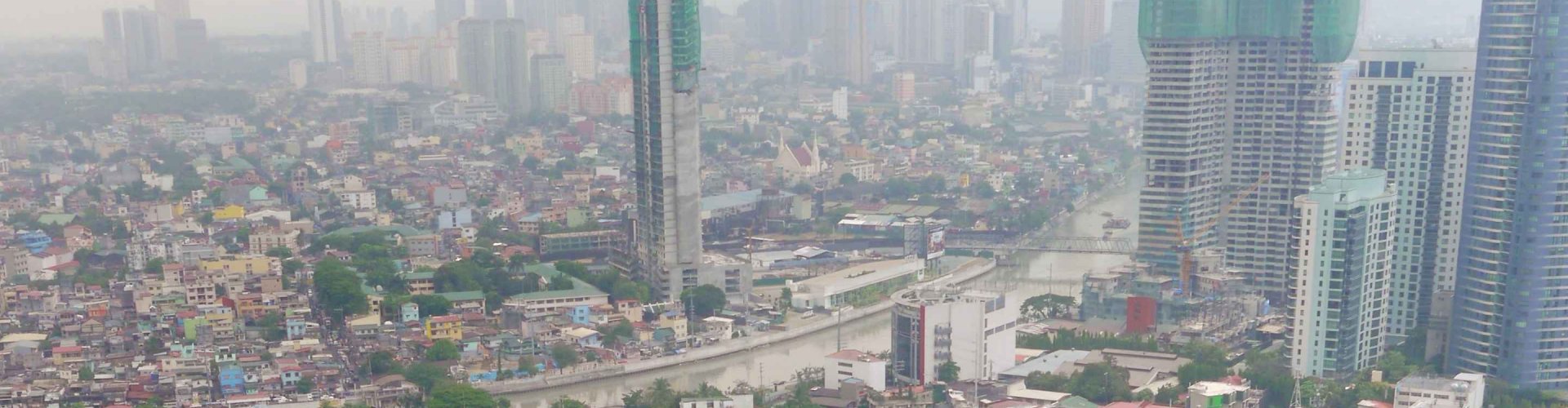 Busy Manila street with jeepneys and MRT train