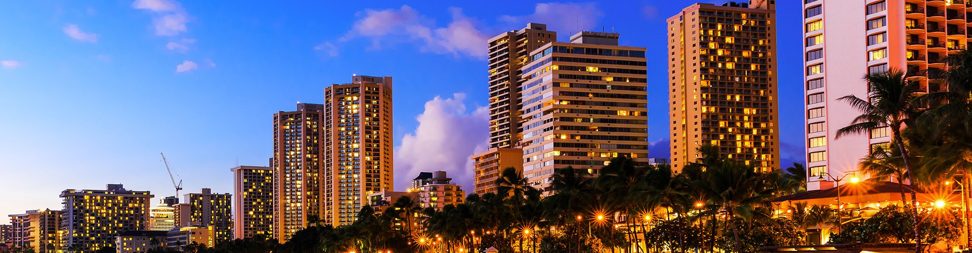 Night tram illuminated on cobblestone street in Honolulu