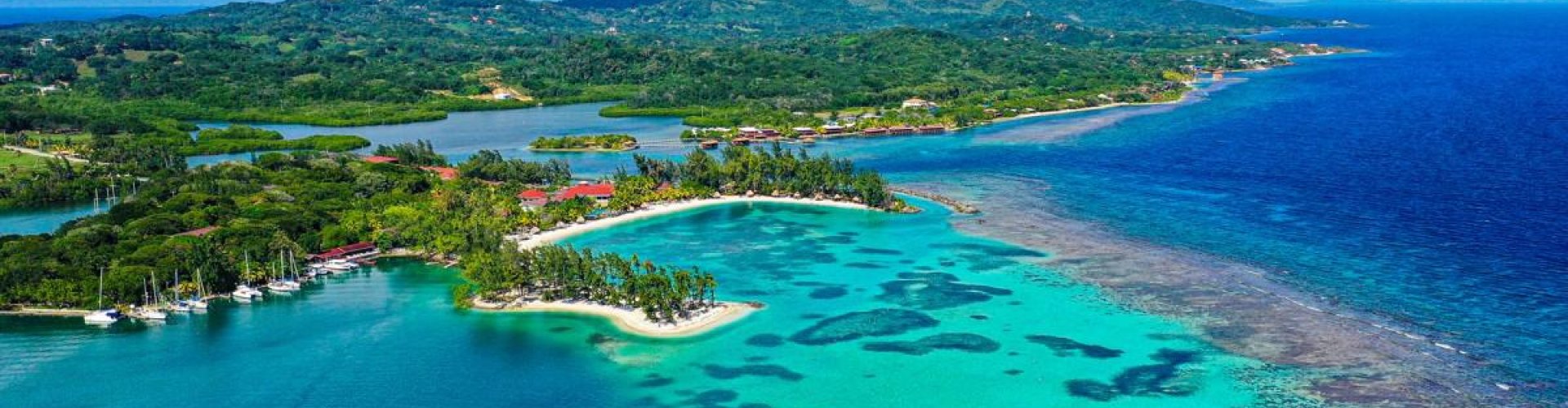 Night tram glowing on cobblestone street in Roatán