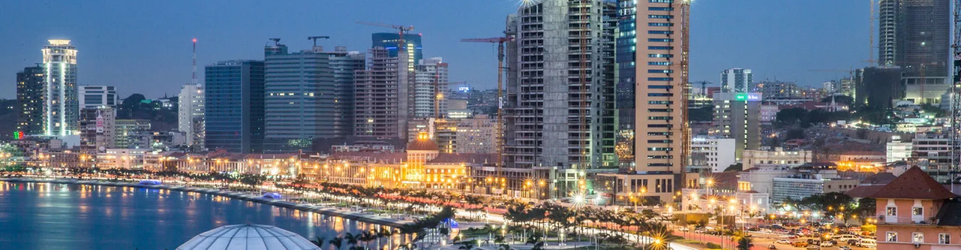 Night tram gliding over Luanda cobblestones