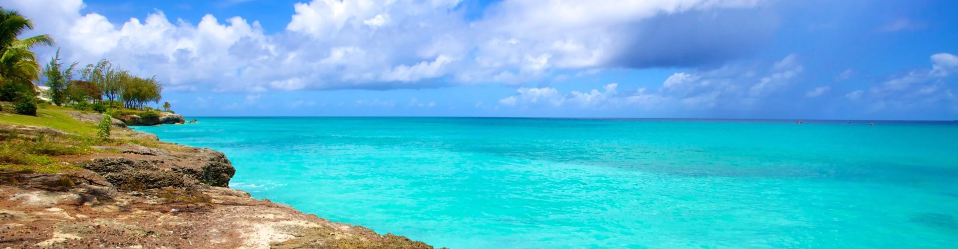 Barbados tram passing colorful street with passengers