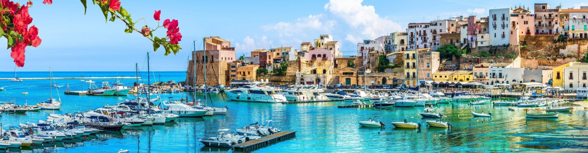 Night tram illuminated on cobblestone street in Trapani