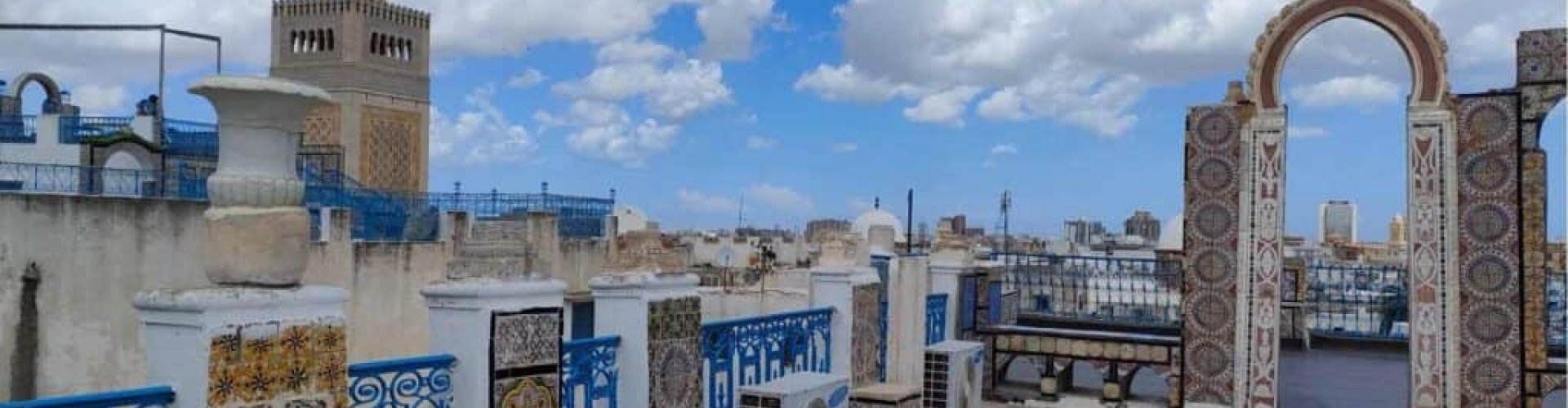 Night tram gliding over cobblestone street in Tunis